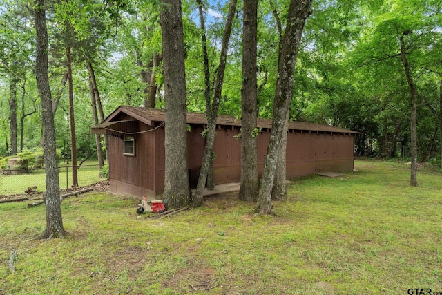 view of outbuilding with an outdoor structure and fence