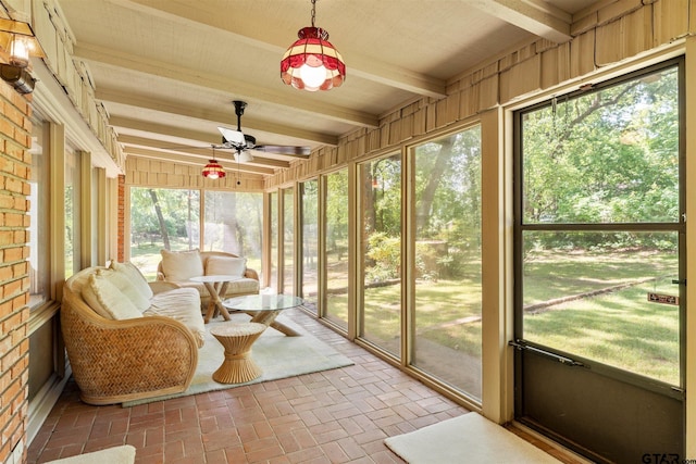 sunroom / solarium with beamed ceiling and a ceiling fan