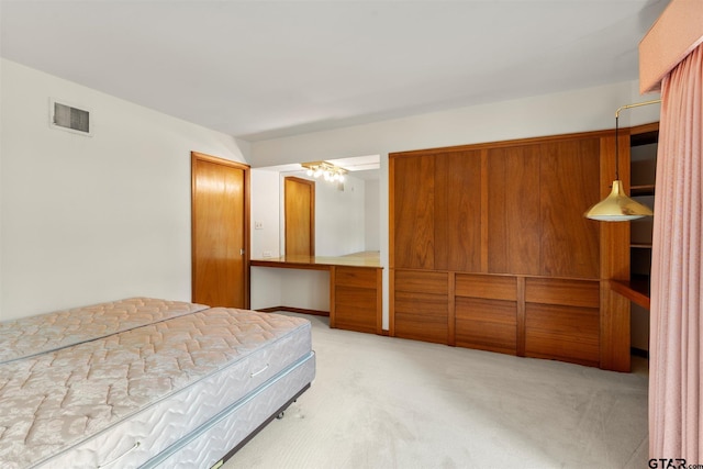 bedroom featuring visible vents and light colored carpet