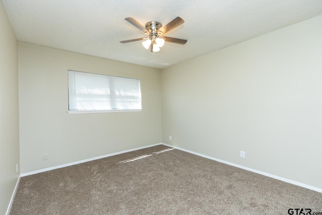 unfurnished room with ceiling fan, a textured ceiling, baseboards, and carpet flooring