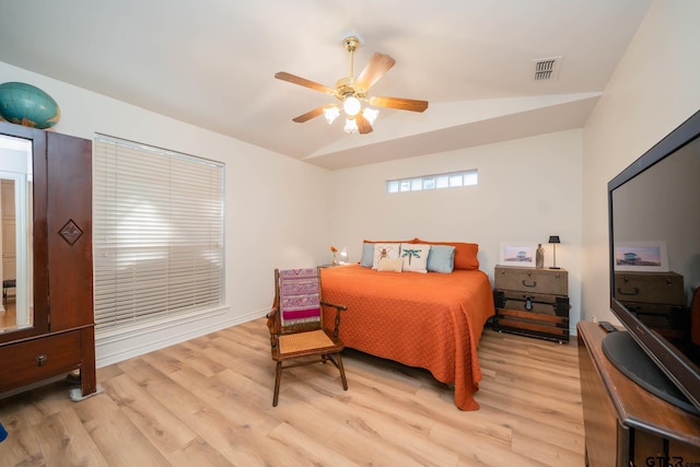 bedroom with ceiling fan, vaulted ceiling, and light hardwood / wood-style flooring