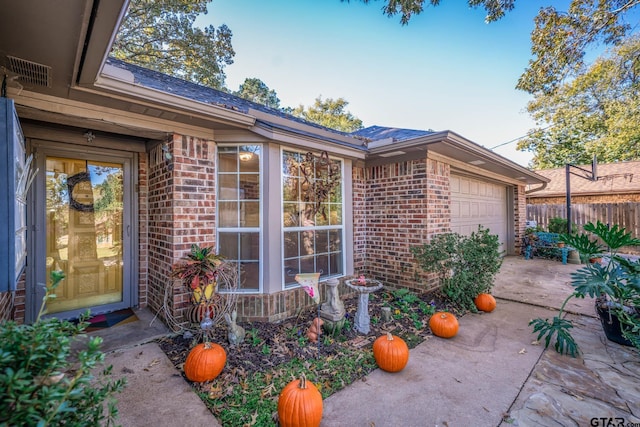 exterior space featuring a garage and a patio area