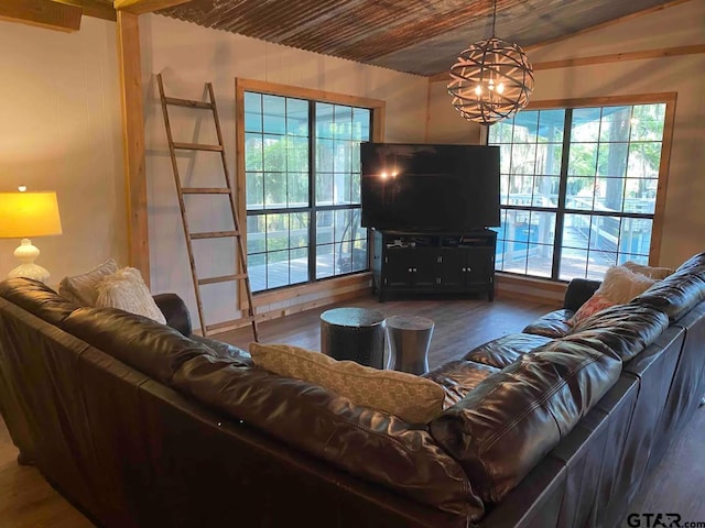 living room featuring a wealth of natural light, dark hardwood / wood-style floors, and a notable chandelier