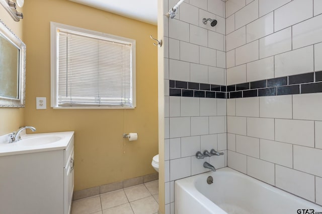 full bathroom with toilet, vanity, tiled shower / bath combo, and tile patterned floors