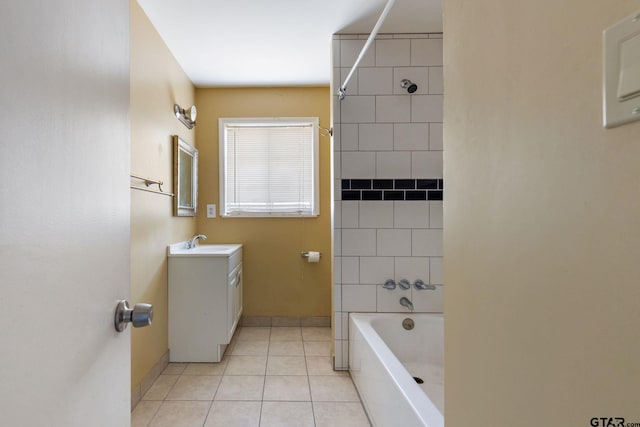 bathroom with tiled shower / bath combo, vanity, and tile patterned flooring