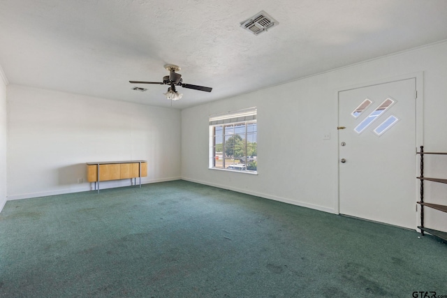 interior space with ceiling fan and dark colored carpet