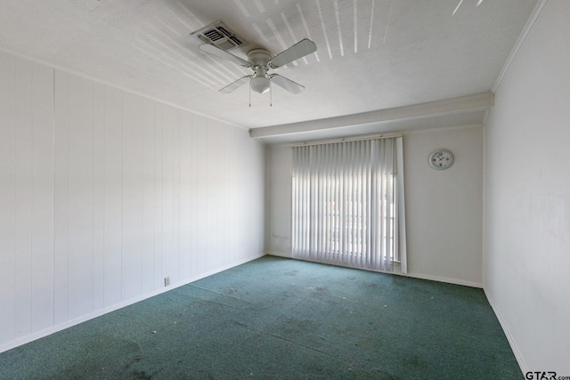 spare room with ornamental molding, ceiling fan, and dark carpet