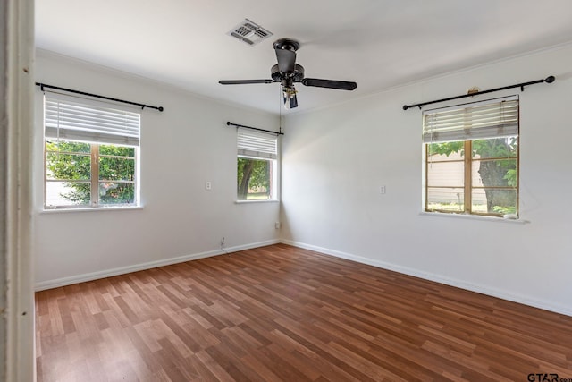 empty room with wood-type flooring, ceiling fan, and crown molding