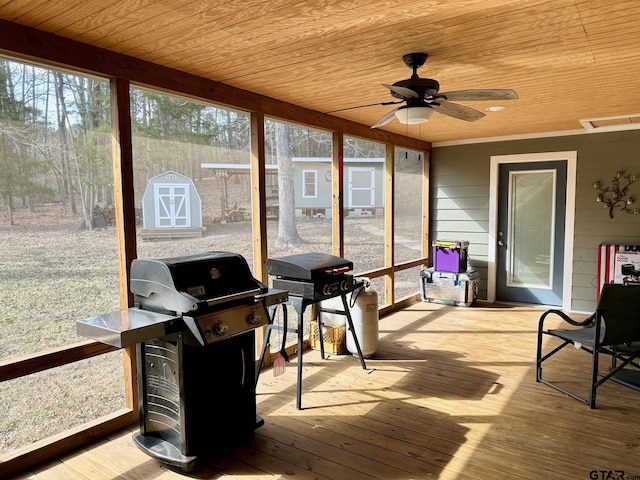 sunroom / solarium featuring wooden ceiling and ceiling fan