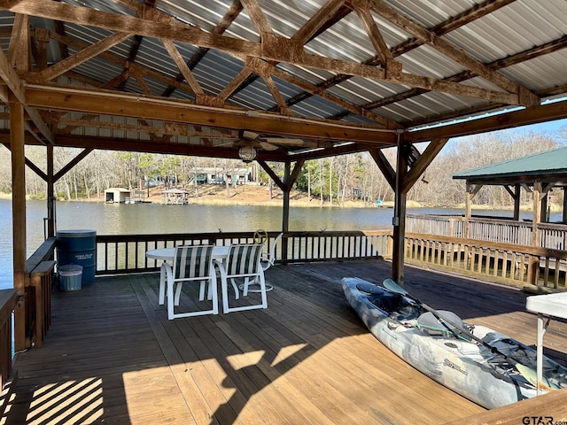 view of dock with a gazebo and a deck with water view