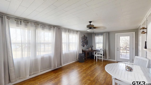 unfurnished sunroom with ceiling fan