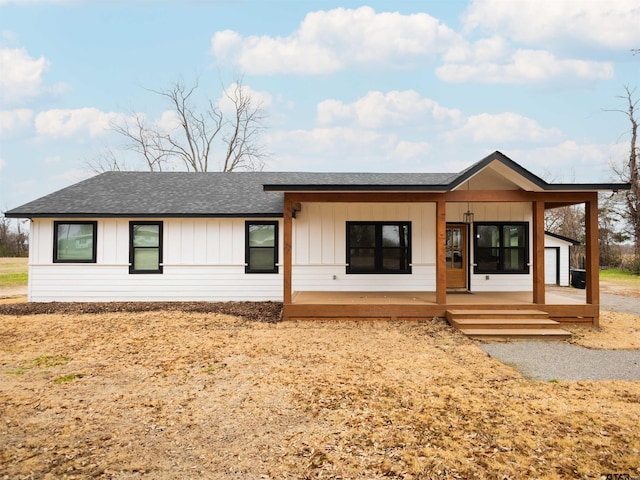 modern inspired farmhouse with board and batten siding, roof with shingles, and a porch