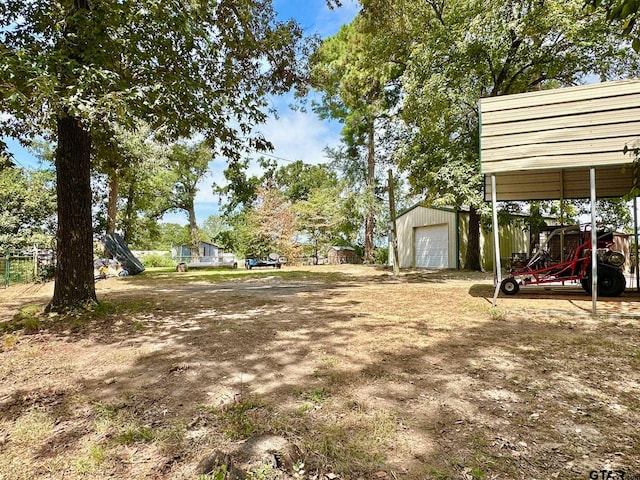 view of yard featuring an outbuilding and a garage