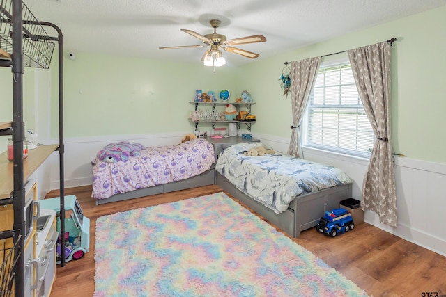 bedroom with ceiling fan and light hardwood / wood-style floors