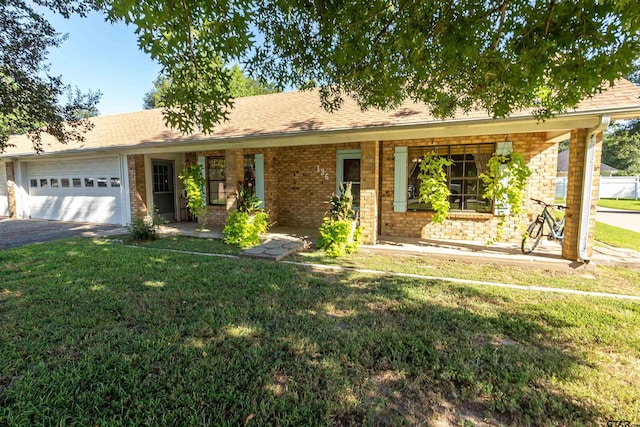 ranch-style house with a garage, covered porch, and a front yard