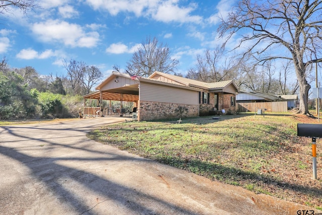 view of property exterior with a yard and a carport