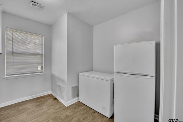 washroom with light wood-type flooring