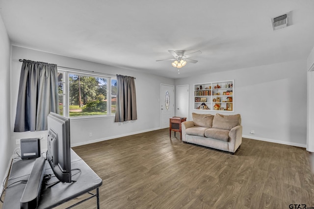 living room featuring ceiling fan and dark hardwood / wood-style flooring