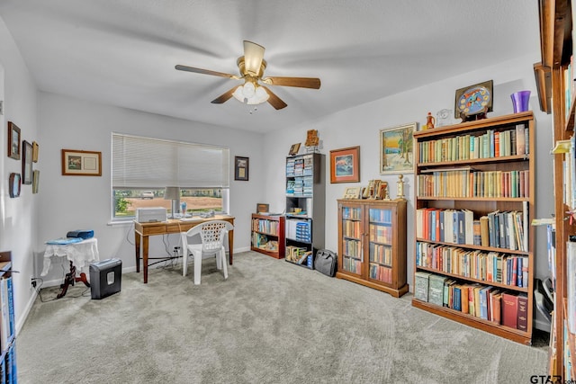 home office featuring carpet, a textured ceiling, and ceiling fan