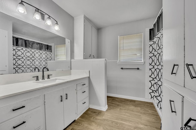 bathroom with hardwood / wood-style floors and vanity