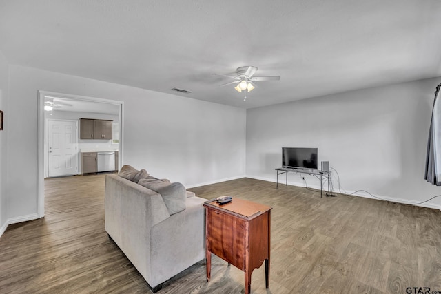 living room featuring hardwood / wood-style floors and ceiling fan