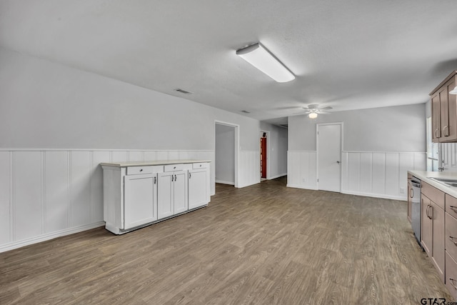 650 Glazner St, Hawkins, TX 75765 - kitchen with wood finished floors, ceiling fan, light countertops, a wainscoted wall, and open floor plan