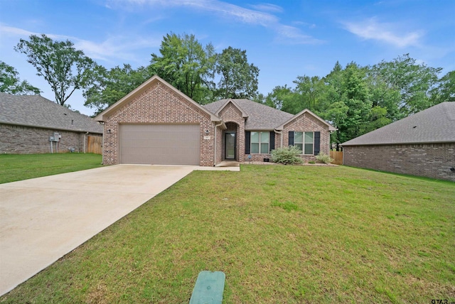 view of front of home featuring a garage and a front yard