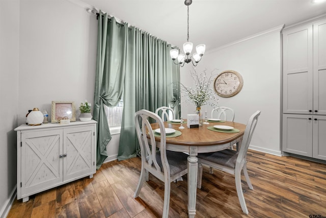 dining room with ornamental molding, dark hardwood / wood-style floors, and an inviting chandelier