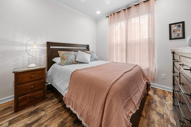 bedroom with ceiling fan, dark hardwood / wood-style floors, and crown molding