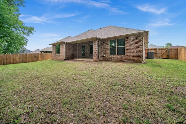 back of property with a patio area, a lawn, and cooling unit