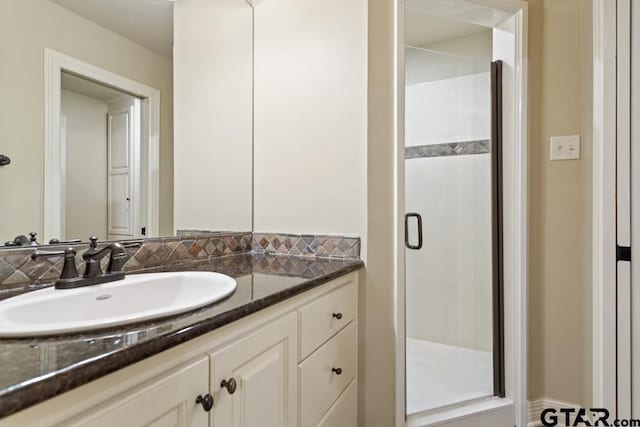 full bathroom featuring a stall shower and vanity