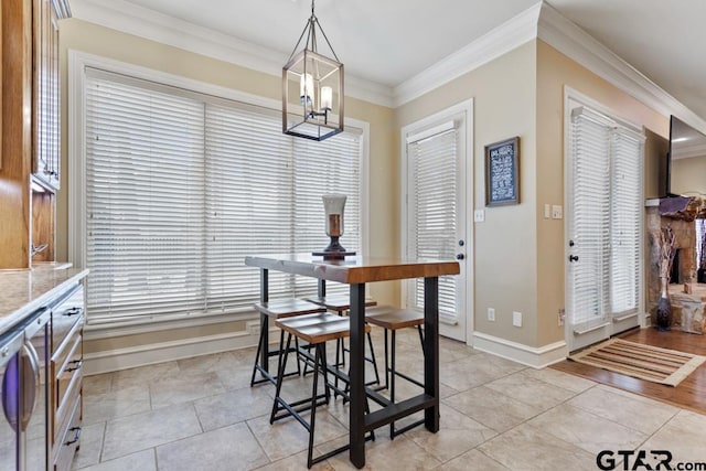 dining area with light tile patterned floors, a notable chandelier, baseboards, a wealth of natural light, and crown molding