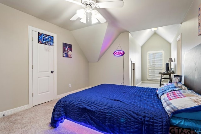 bedroom featuring light carpet, vaulted ceiling, baseboards, and ceiling fan