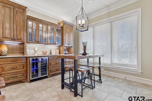 kitchen featuring glass insert cabinets, beverage cooler, light countertops, and brown cabinets