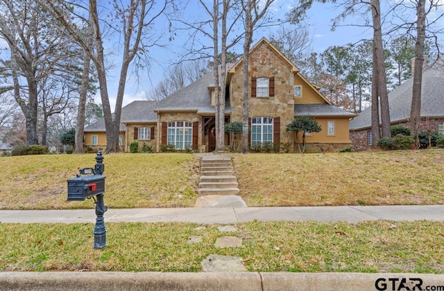 view of front of property featuring a front yard and stone siding