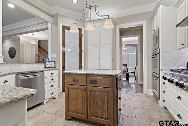 kitchen with light stone countertops, appliances with stainless steel finishes, and white cabinets