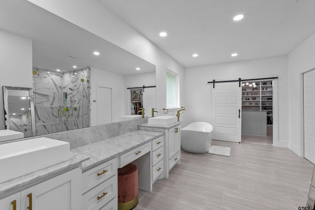 2680 Primera Rd, Tyler, TX 75705 - full bath featuring a marble finish shower, recessed lighting, a soaking tub, vanity, and a spacious closet