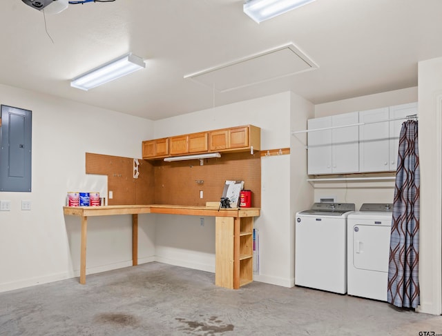 garage featuring electric panel and washing machine and clothes dryer