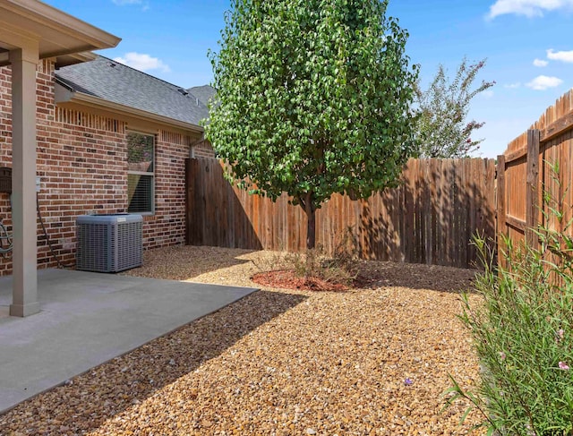 view of yard featuring central AC unit and a patio area