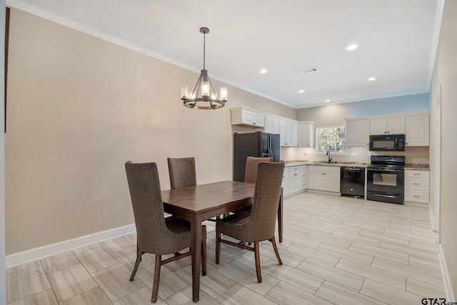 dining room with a notable chandelier, crown molding, and sink