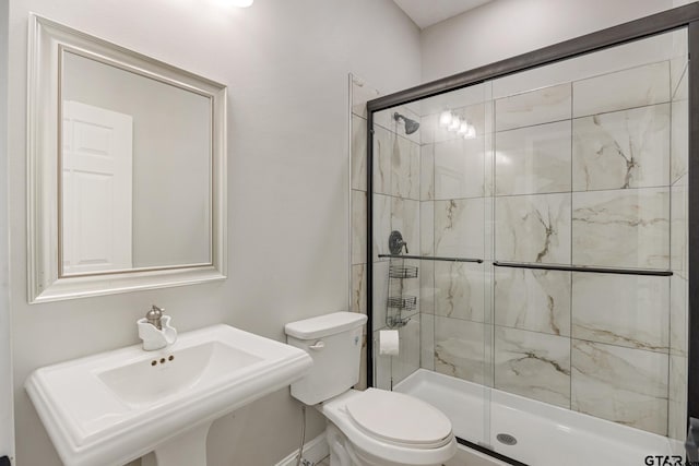 bathroom with an enclosed shower, toilet, and sink