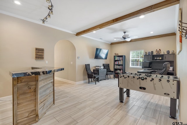 recreation room featuring beam ceiling, ceiling fan, track lighting, and ornamental molding