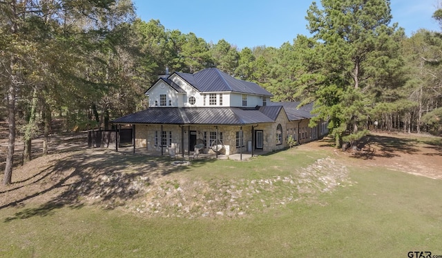 back of house with a patio area and a yard