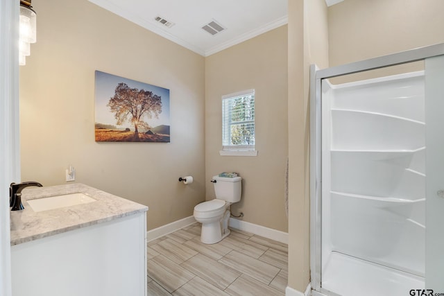 bathroom with toilet, vanity, ornamental molding, and walk in shower