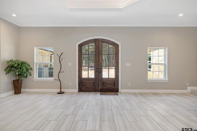 foyer with french doors, light hardwood / wood-style flooring, and ornamental molding