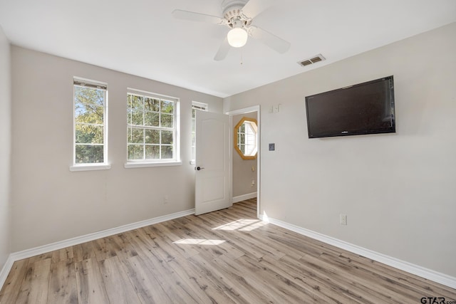 spare room featuring ceiling fan and light hardwood / wood-style floors