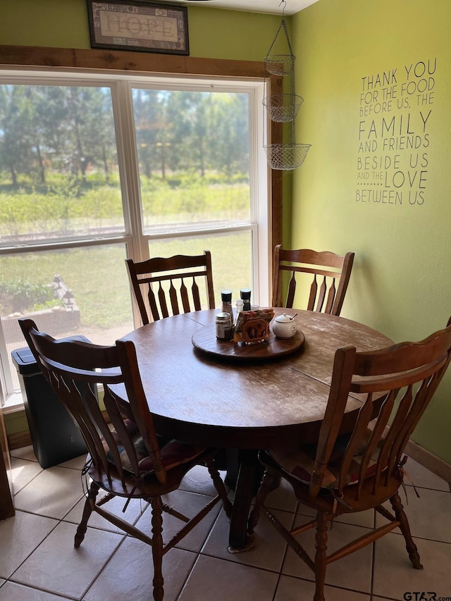 dining space with light tile patterned flooring and a healthy amount of sunlight