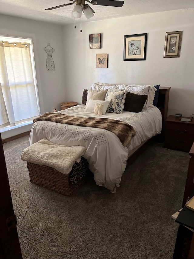 carpeted bedroom featuring a textured ceiling and ceiling fan