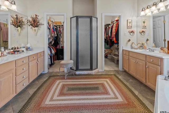 bathroom featuring an enclosed shower, vanity, and tile patterned floors