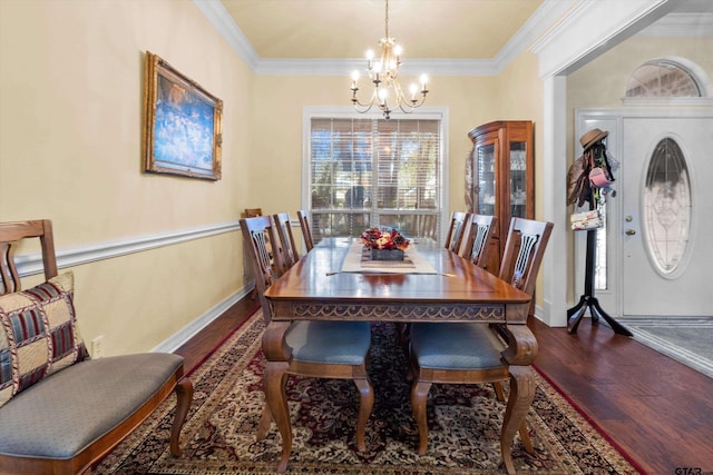 dining room with dark hardwood / wood-style flooring, a notable chandelier, and crown molding